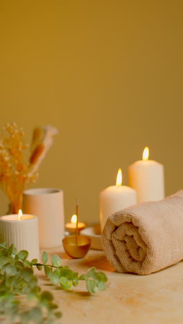 Vertical-Video-Still-Life-Of-Lit-Candles-With-Dried-Grasses-Incense-Stick-And-Soft-Towels-As-Part-Of-Relaxing-Spa-Day-Decor-1